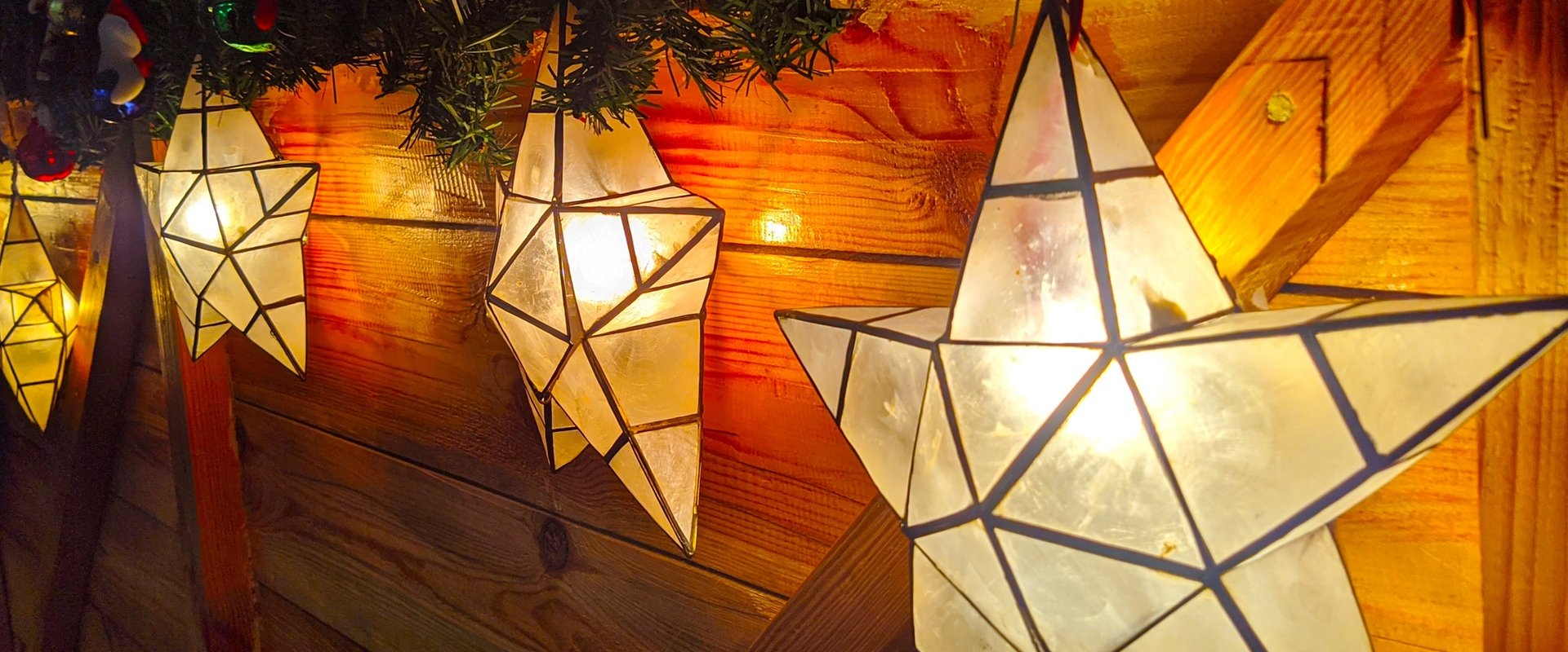 Star-shaped Christmas lanterns lit and hanging as festive decorations