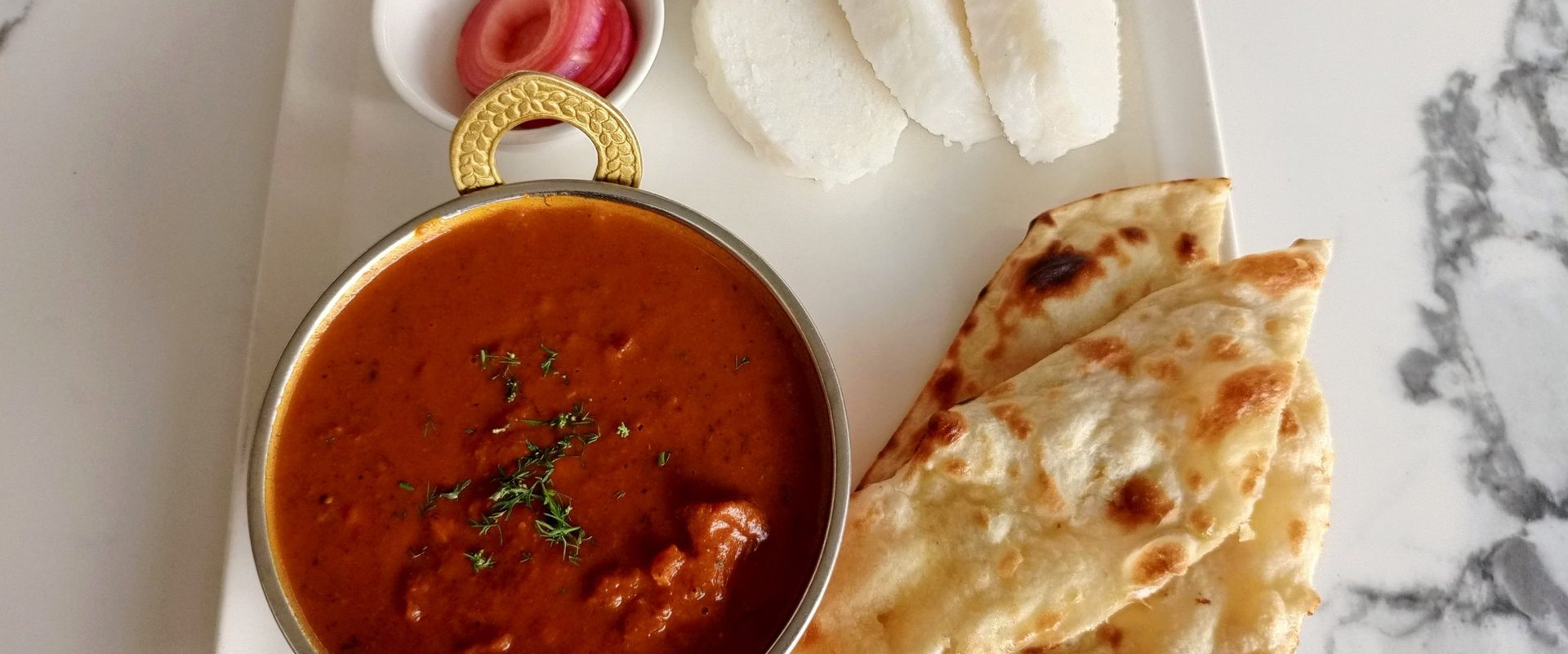 Indian-style meal served on a plate, representing fellowship and shared food